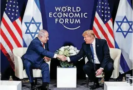  ?? [AP PHOTO] ?? President Donald Trump shakes hands Thursday with Israeli Prime Minister Benjamin Netanyahu at the World Economic Forum in Davos, Switzerlan­d.