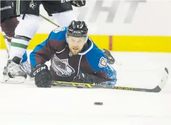  ?? Brent Lewis, Denver Post file photo ?? Avalanche center John Mitchell keeps his eye on the puck after falling to the ice in a game Feb. 14, 2015, at the Pepsi Center.