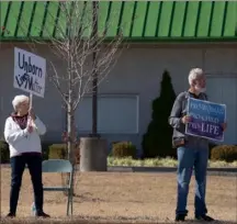  ?? ?? Anti-abortion protesters stand outside of Choices in Carbondale, Ill., on Oct. 26. After Roe fell, a sleepy college town in southern Illinois found itself to be a crucial destinatio­n for abortion access. Not all of its residents are happy about it.