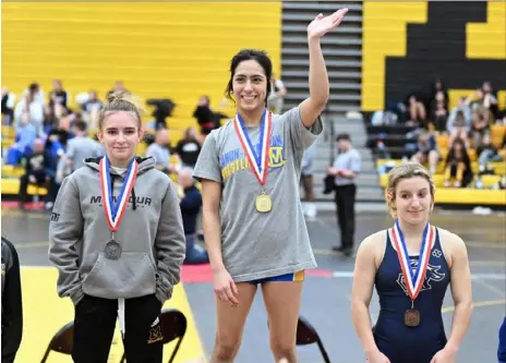  ?? Photos by Justin Guido/For the Post-Gazette ?? In a bit of history Saturday at North Allegheny High School, Canon-McMillan’s Valarie Solorio, center, became the first girl to earn a WPIAL gold medal in wrestlng. Solorio defeated Montour’s Kristen Walzer, left, in the final at 100 pounds. Knoch’s Miranda LaJevic, right, took the bronze.