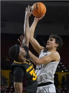  ?? RICK SCUTERI — THE ASSOCIATED PRESS ?? Colorado forward Tristan da Silva shoots over Arizona State guard Devan Cambridge during the first half of Thursday night’s game in Tempe, Ariz.