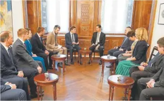  ?? Handout, AFP/Getty Images ?? Syrian President Bashar al-Assad, back right, receives a delegation from the Russia's ruling United Russia political party in Damascus.