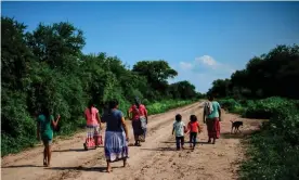  ?? Photograph: Ronaldo Schemidt/AFP/Getty Images ?? Wichí indigenous women and their children walk along a road in Salta province, Argentina.