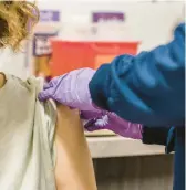  ?? ?? A patient receives the COVID-19 vaccine in Baltimore. ROSEM MORTON/THE NEW YORK TIMES 2022