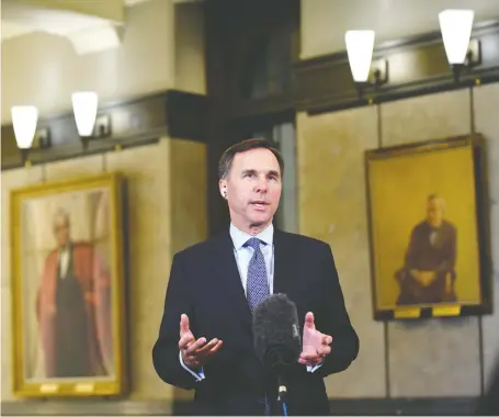  ?? JUSTIN TANG/THE CANADIAN PRESS ?? Finance Minister Bill Morneau does a remote TV interview in Ottawa on Wednesday. He says he would like to issue more longer-term debt, but he might have to work harder to get the desired yield by committing to rein in the budget, says Kevin Carmichael.