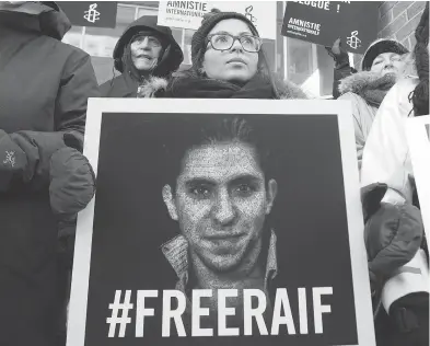 ?? RYAN REMIORZ / THE CANADIAN PRESS FILES ?? Ensaf Haidar, wife of blogger Raif Badawi, takes part in a rally for his freedom in Montreal in 2015. Badawi has been sentenced to 10 years in prison and 1,000 lashes for the crime of “insulting Islam through electronic channels.”