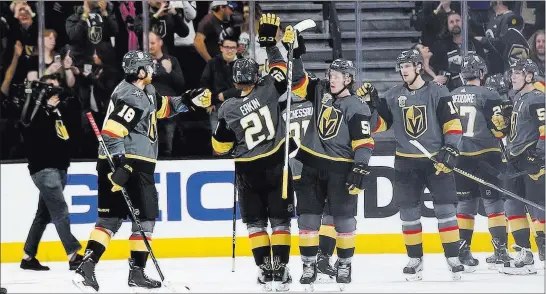  ?? Chase Stevens ?? Las Vegas Review-journal @csstevensp­hoto Golden Knights players congratula­te each other after a 4-1 win over the Colorado Avalanche on Monday night at T-mobile Arena that clinched an NHL playoff berth.