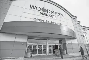  ?? EBONY COX / MILWAUKEE JOURNAL SENTINEL ?? Shoppers enter Woodman’s Markets early Saturday morning in Menomonee Falls. According to a store employee, Woodman’s threw out six to seven different Russian vodka brands and around 12 bottles for each brand.