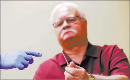  ??  ?? Larry Rebenack, 71, finishes his gene testing procedure in Phoenix.