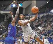  ?? Jessica Hill / Associated Press ?? UConn’s Crystal Dangerfiel­d passes around DePaul’s Chante Stonewall, left, on Wednesday night at the XL Center in Hartford.