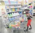  ?? AFP ?? A Jamaican boy stocks up before the arrival of Hurricane Matthew.