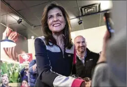  ?? PHOTOS BY ARTIE WALKER JR./AP ?? Republican presidenti­al candidate Nikki Haley shakes hands with a supporter before a campaign event on Thursday in Columbia, S.C.