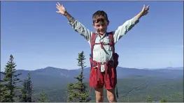  ?? JOSHUA SUTTON ?? Harvey Sutton, 5, raises his arms on a mountain top in Bigelow Preserve, Maine, while hiking the Appalachia­n Trail with his parents.