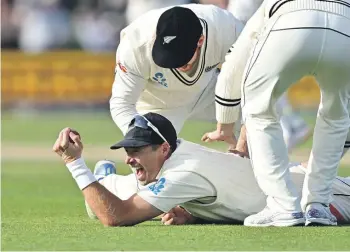  ?? ?? New Zealand captain Tim Southee pulls in a one-handed grab at slip to dismiss Australian opener Usman Khawaja late in the day. GETTY IMAGES