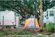  ?? KIM PORTER AP PHOTO VIA ?? In this Dec. 15 photo shows people living in tents and trailers in Rockport, Texas. The federal government typically spends up to $150,000 apiece, not counting utilities, maintenanc­e or labor, on the trailers it leases to disaster victims, then...