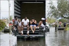  ?? GERALD HERBERT — THE ASSOCIATED PRESS ?? People are evacuated from floodwater­s Aug. 30 after Hurricane Ida in LaPlace, La.