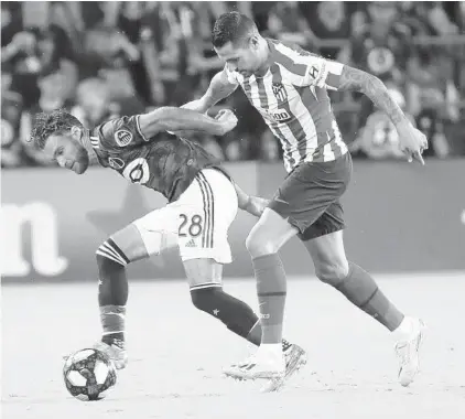  ?? STEPHEN M. DOWELL/ORLANDO SENTINEL ?? MLS player and Longwood native Graham Zusi, left, battles Atlético Madrid’s Vitolo for the ball during the MLS All-Star Game at Exploria Stadium on Wednesday night.