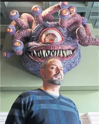  ?? STEVE RUSSELL PHOTOS TORONTO STAR ?? Jason Kapalka, owner of nerdy bar Storm Crow Manor, in the Hunt Room with mounted head of a Beholder from the board game Dungeons &amp; Dragons.