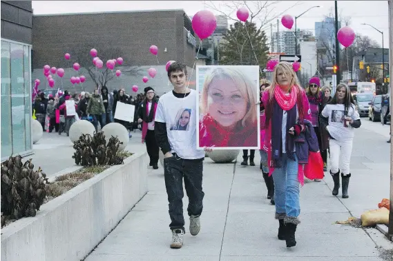  ??  ?? A group marches along a downtown London street in memory of Josie Glenn on Monday. Glenn was slain last month. Derek Ruttan