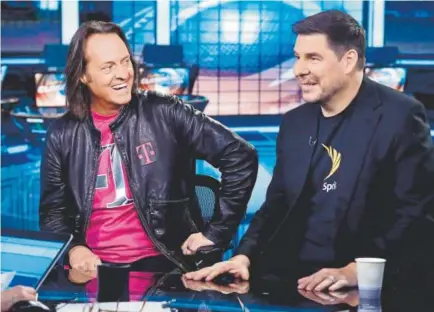  ?? Richard Drew, The Associated Press ?? T-Mobile CEO John Legere, left, and Sprint CEO Marcelo Claure are interviewe­d by Liz Claman during her “Countdown to the Closing Bell” program on the Fox Business Network in New York on Monday.