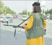  ?? AGENCIES ?? BUZZ IN KABUL: (L-R) A child carries loaves of bread; people queue up outside a bank; a Taliban member stands guard in front of the internatio­nal airport; and women cross a street.