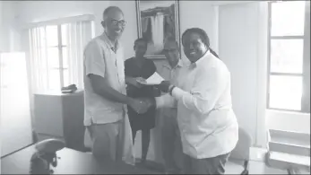  ?? Photo) (Ministry of Natural Resources ?? Permanent Secretary Joslyn McKenzie (right) and TCG’s Managing Director Timothy McIntosh shaking hands on the deal.