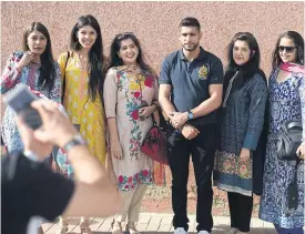  ??  ?? Amir Khan poses for photograph­s with fans in Rawalpindi, Pakistan last year.