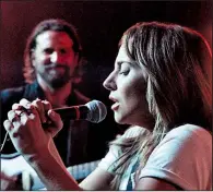  ??  ?? Ally (Lady Gaga) sings as Jackson Maine (Bradley Cooper) watches in A Star Is Born.