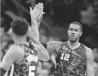  ?? Kin Man Hui / Staff photograph­er ?? The Spurs' LaMarcus Aldridge, right, made great strides during the 2017-18 season of shoulderin­g the load and leading the way. He credited Manu Ginobili in a tweet for being a great example.