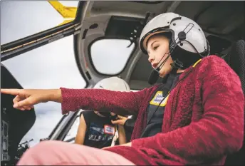  ?? NATHAN BURTON/Taos News ?? Querida Marquez, 11, points towards the navigation­al controls of a helicopter during the Taos Youth Flight Rally on Saturday (Sept. 10). The annual event educates Taos youth about aviation and offers free airplane rides to those who attend.