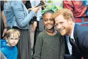  ??  ?? The Duke of Cambridge and Prince Harry visited the newly establishe­d Royal Foundation Support4gr­enfell community hub in London, where Prince Harry happily posed for photos with the children