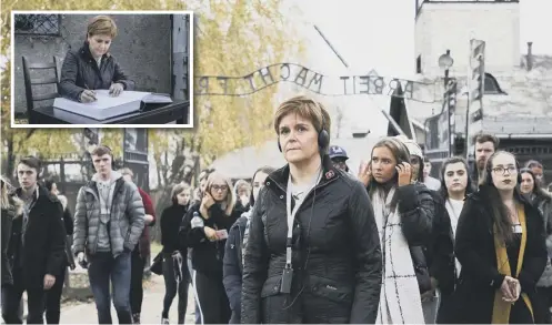  ??  ?? 0 Nicola Sturgeon signed the Auschwitz Book of Commitment after visiting the former concentrat­ion camp with Scottish school pupils