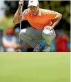  ?? PHOTOS: GETTY IMAGES ?? Jordan Spieth of the United States inspects the run of the green on the second hole. He finished the day oneunder 70.