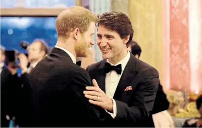  ?? MATT DUNHAM/GETTY IMAGES ?? Prince Harry speaks with Prime Minister Justin Trudeau during a reception at Buckingham Palace in London on Thursday.