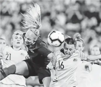  ?? DAVID BUTLER II/USA TODAY SPORTS ?? U.S. midfielder Julie Ertz, center, and Australia forward Hayley Raso (16) work for the ball in the Tournament of Nations on Sunday.