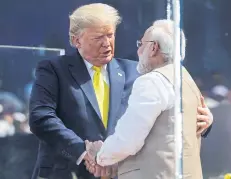  ?? REUTERS ?? US President Donald Trump embraces Indian Prime Minister Narendra Modi at Sardar Patel Gujarat Stadium in Ahmedabad, India yesterday.