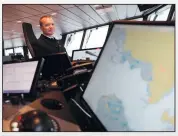  ?? ?? Capt. Will Whatley, commander of the British Antarctic Survey Ship Sir David Attenborou­gh, sits on the bridge.