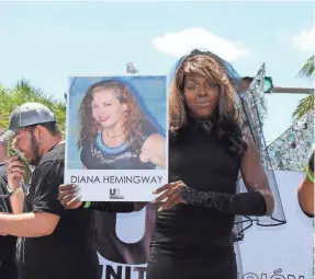  ?? COURTESY OF ARYAH LESTER ?? Aryah Lester holds a salute to Diana Hemingway, an activist who took her own life in 2016, at Miami Beach’s Gay Pride in April 2017. Lester, 38, founded Trans-Miami and is an activist for LGBT rights.