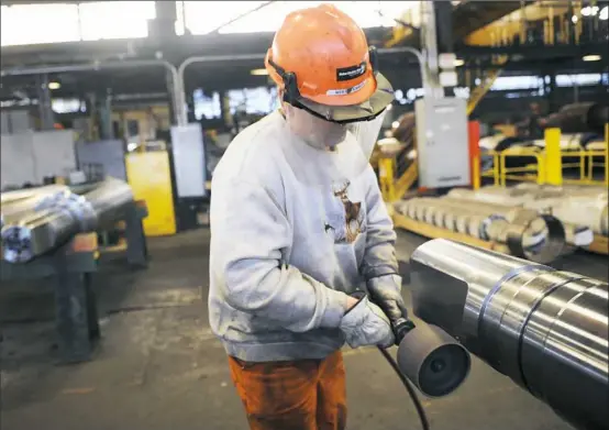  ?? Nate Guidry/Post-Gazette ?? An Ampco-Pittsburgh worker in Carnegie. The company reported a $7 million loss in the third quarter, largely due to U.S. tariffs.