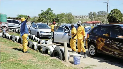  ?? Picture: SUPPLIED ?? LINED UP: Three ex-convicts are paving a way for a better life for themselves and their community by having transforme­d a dumpsite into a venue to run their car wash business