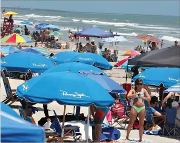  ?? Associated Press ?? Cocoa Beach, Fla., is packed with Memorial Day beachgoers on Saturday. The beaches are open for business again during the coronaviru­s epidemic.