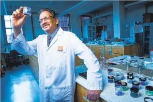  ?? COURTESY OF OREGON STATE UNIVERSITY VIA NYT ?? Mas Subramania­n in his lab at Oregon State University holds a sample of his unexpected invention, a blue pigment known as YInMn, named for the elements yttrium, indium and manganese.