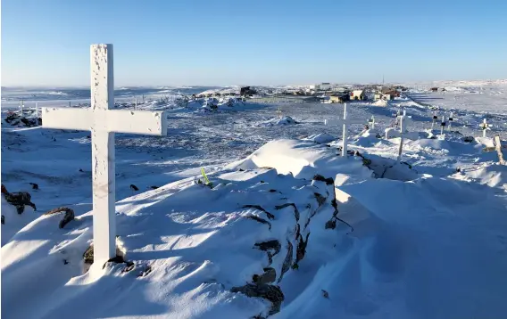  ??  ?? The grave of Darryl Kaunak, a father in his early 30s from Naujaat who was mauled by a polar bear while on a hunting trip last August