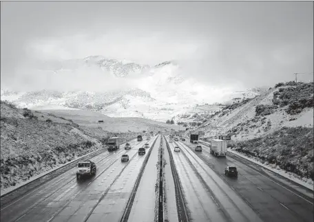  ?? Photograph­s by Al Seib Los Angeles Times ?? SNOW BLANKETS the top of the Tejon Pass, elevation 4,160 feet, on Wednesday. The Grapevine section of the 5 Freeway through the mountain pass is expected to see up to 6 inches of snow, with the bulk of it falling Thursday, a National Weather Service forecaster said.