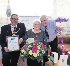  ??  ?? Together Provost McAllan presents Jean and Jim with a bouquet of flowers