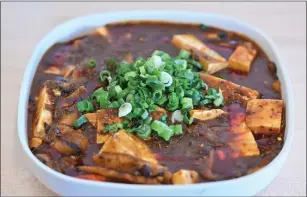  ?? PHOTOS BY SHERRY LAVARS — MARIN INDEPENDEN­T JOURNAL ?? The spice and chilis in the Mapo Tofu with Mushroom give it intensely delicious flavors.