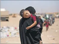  ?? AP PHOTO ?? A child sleeps on his mother’s shoulder after a perilous journey on foot to flee heavy fighting in their neighborho­od between Iraqi forces and Islamic State militants, at a processing centre in west Mosul, Iraq, Thursday.