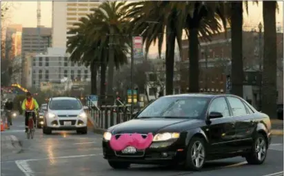  ?? JEFF CHIU — THE ASSOCIATED PRESS FILE ?? A Lyft car crosses Market Street in San Francisco. In a big win for labor advocates, the California Supreme Court has limited the ability of businesses to classify workers as independen­t contractor­s, which could affect a range of workers in the...