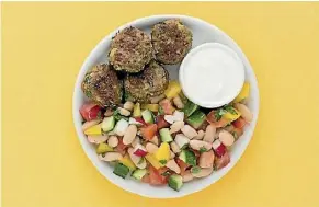  ??  ?? Greek-spiced lamb cakes with cucumber, tomato and radish salad.