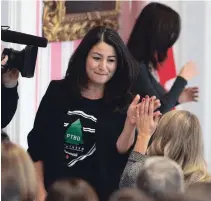  ?? JUSTIN TANG THE CANADIAN PRESS ?? Maryam Monsef, high fives Melanie Joly during the swearing-in ceremony on Wednesday. Monsef was rocking a Peterborou­gh Northern Originals T-shirt under her blazer at the ceremony.